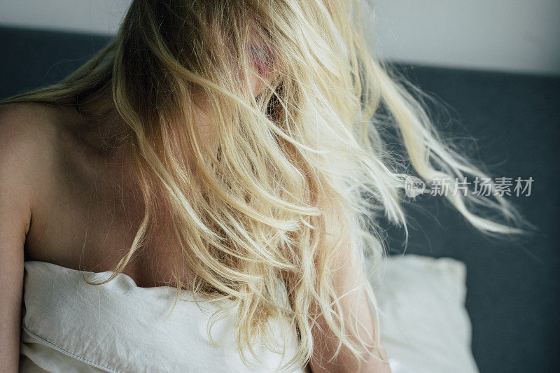 Gorgeous Blonde Woman Playing With her Hair in Bed